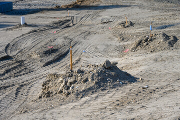 Job site preparation, site cleared and leveled, survey stakes in the dirt, new residential...