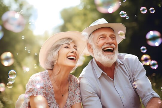 happy senior couple together smiling with soap bubbles at outdoor