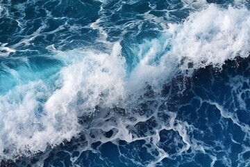 Sea wave with foam, top view. Blue ocean wave background. Close up view of ocean water surface. Sea wave texture
