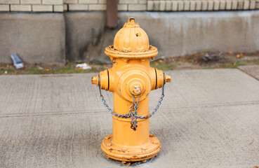 fire hydrant stands on a city sidewalk, symbolizing safety, preparedness, and emergency response,...