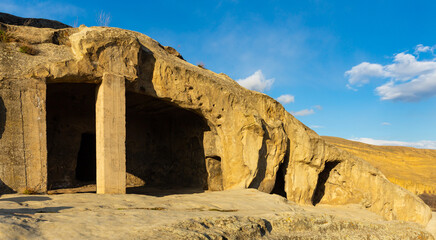 Ancient cave city of Uplistsikhe in eastern Georgia in sunny day - obrazy, fototapety, plakaty