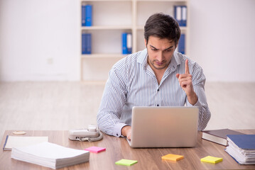Young male employee working in the office
