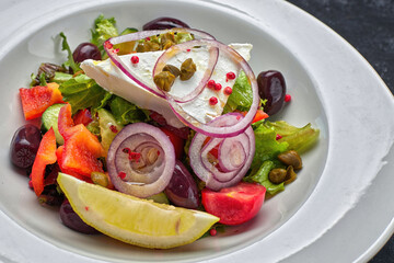 Greek salad with vegetables and cheese, dark background