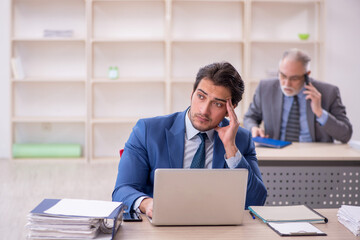 Two male colleagues working in the office