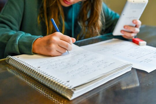 Teenage girl doing her homework - Powered by Adobe