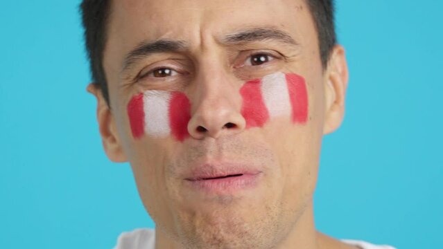 Very nervous man supporting peruvian team during a difficult match.