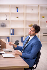 Young male employee working in the office
