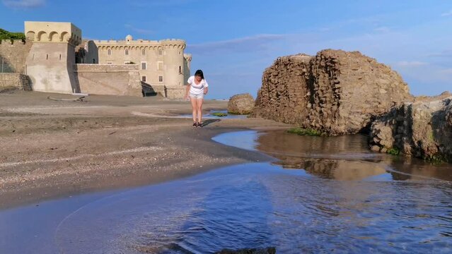Girl collecting shells on Ladispoli beach