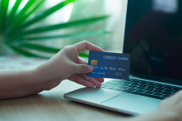 Housewife, maid, ordering products online, paying online, using credit card to pay for products, online shopping concept