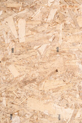 Closeup of a section of new Oriented Strand Board (OSB) engineered wood used in home construction
