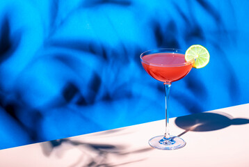 Siesta cocktail drink with tequila, grapefruit and lime juice, syrup and red bitter, liqueur. Blue...