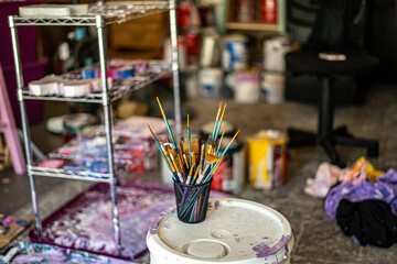 Cup of Assorted Paint Brushes in Art Studio Cute Artistic Backgrounds Empty Space Vibrant Color