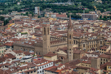 Fototapeta na wymiar The church tower of Badia Fiorentina and Bargello palace in aerial view, Florence ITALY