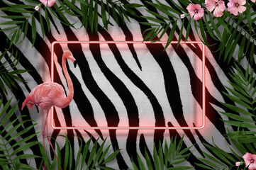 Creative composition made of tropical leaf and pink flamingos with neon light on wall background zebra texture with copy space for text.Caribbean concept, great idea for advertising