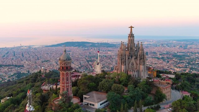 Aerial view of Barcelona skyline with the Expiatory Church of the Sacred Heart of Jesus at sunrise. Tibidabo mountain. Catalonia, Spain