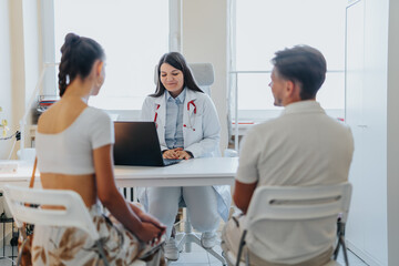 Experienced Medical Professionals Discussing Diagnosis and Treatment Options with Happy Couple in Office