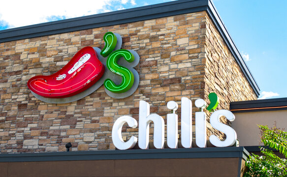 Ocala, FL USA - OCTOBER 14, 2023: Chilis Restaurant Exterior. Close up view of front pepper logo showing lighting configuration inside. American casual dining restaurant chain Founded in Texas