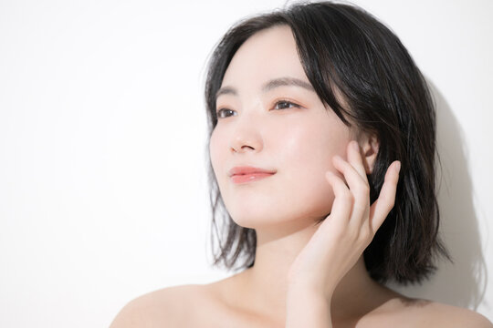 Beauty image of a young woman Touching cheeks Looking up