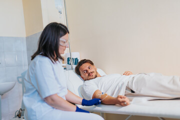 Fototapeta premium Experienced doctor checking lab reports, providing medical care and treatment to a patient in a hospital room.