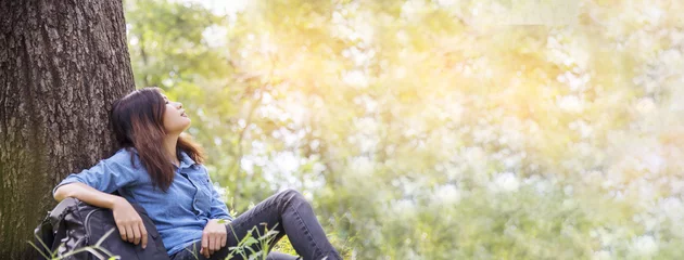 Fotobehang Banner Portrait Asian Woman relaxing in green park. Happy Relax asian woman smiling face at outdoors garden. Women enjoy nature freedom lifestyle. Greenery wellbeing outside in nature with copy space © aFotostock