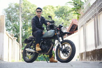 Asian man motorbike in black leather jacket travel rider trip. Handsome Men wear sunglass outdoor...