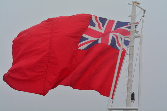 Bermuda flag flying with foggy white grey background