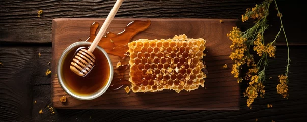 Foto op Plexiglas Top view of raw honeycomb piece on a rustic wooden table © Georgina Burrows