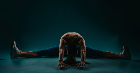 Confident fit girl showcases powerful body transformation in dark studio. Exercises abs, biceps, chest, triceps. Motivates with impressive progress and results. Silhouette shot inspires fitness goals.