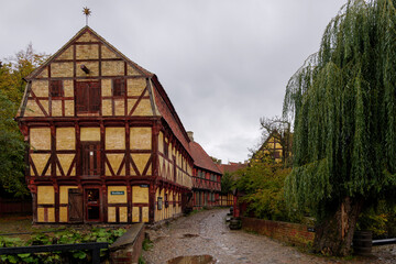 Outdoor overcast scenery street view and old traditional wooden houses at Den Gamle By in Aarhus, Denmark. 