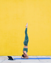 Sporty woman exercising on yoga mat raising legs up