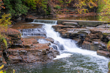 Late afternoon autumn photo of a waterfall in Ithaca NY, Tompkins County New York.	