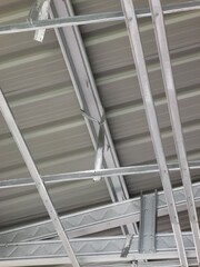 Aluminum ceiling structure inside of a house at construction site.