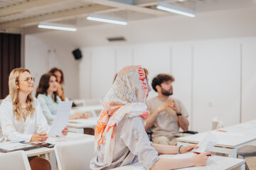 Group of businesspeople gathered in a seminar meeting in a white classroom, conference meeting