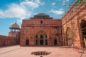 Fototapeta premium Decorative ritual pool( fountain) in Red Fort of Agra, India. Under renovation. Agra Fort is a historic red sandstone fort and a UNESCO World Heritage Site.