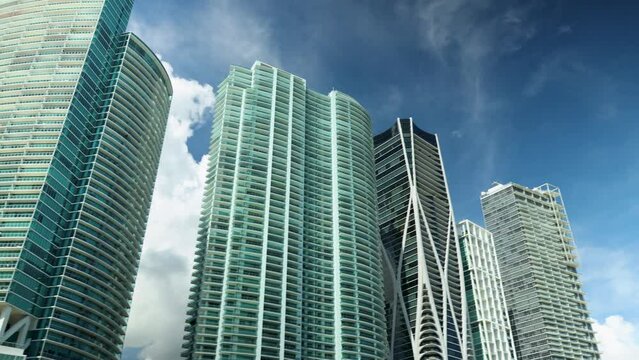 panning footage of high rise luxury condos, hotels and skyscrapers with blue sky and clouds in Miami Florida USA