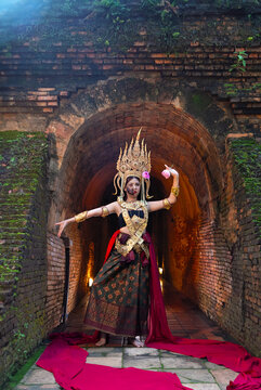 Halloween day concept. Beautiful woman in Apsara dancer costume traditional ASEAN culture at ancient temple. Portrait of asian woman in Apsara style make up ghost face with blood,Horror scene, devil