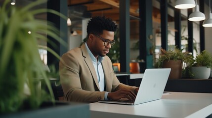 African-American male businessman in office with laptop