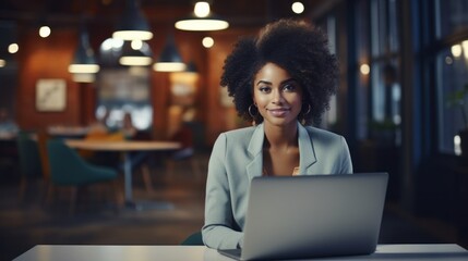 American female on laptop in office