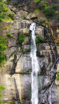 Beautiful waterfall in the rainforest view from above. Rawana Falls, Sri Lanka. Vertical video.