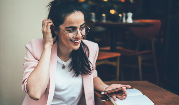 Excited Young Woman Browsing Phone Spending Time In Cafe