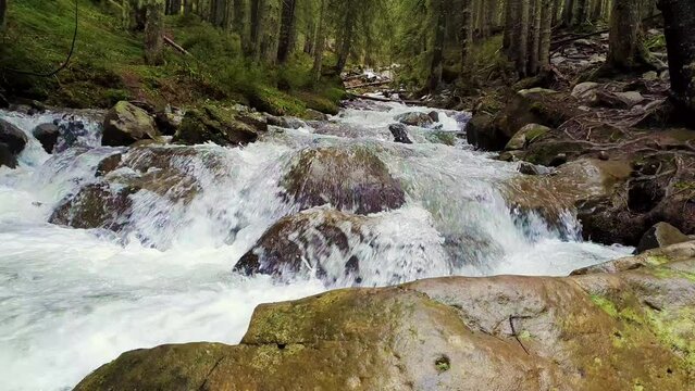 Great scenery view as river flowing through the mountain hills wild nature. Prut river in Carpathian Mountains, Hoverla Peak. Fast stream water with waterfalls through the rocks