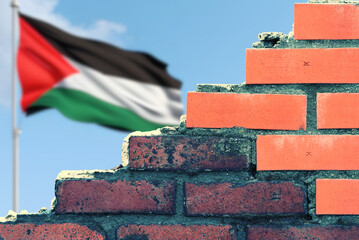 Flagge der Palästina hinter einer Mauer