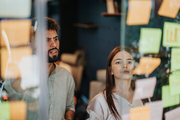 Business Professionals Engaged in Collaborative Brainstorming Session in Modern Office