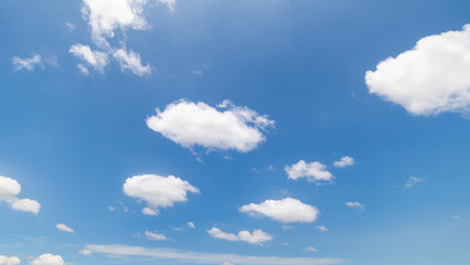 Panoramic view of clear blue sky and clouds, Blue sky background with tiny clouds. White fluffy clouds in the blue sky. Captivating stock photo featuring the mesmerizing beauty of the sky and clouds.