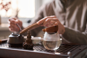 Tea master pours white tea to guests. Everything is ready for the tea ceremony. The ceremony is according to all the rules, but not in the classical style. Adapted to a modern apartment.