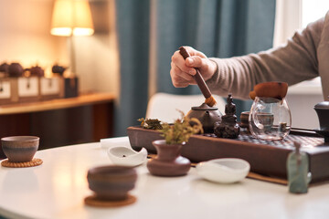 Tea master pours white tea to guests. Everything is ready for the tea ceremony. The ceremony is according to all the rules, but not in the classical style. Adapted to a modern apartment.