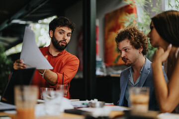 Architects and engineers discussing blueprint. Creative business cooperation in construction industry. Successful project development. Young executives meeting at coffee bar for urban planning.