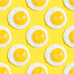 Seamless pattern with sunny side egg on yellow background.