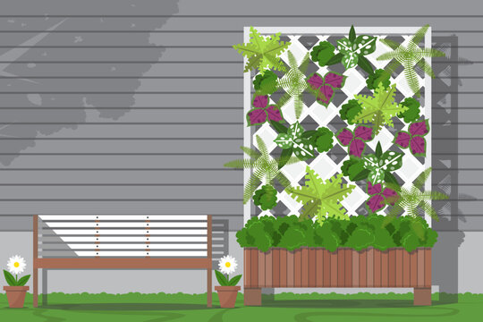 Vertical garden with bench in garden next to the house on shera wood siding background.