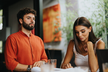A diverse team of architects, engineers, and designers gather at a coffee bar, discussing blueprint details.